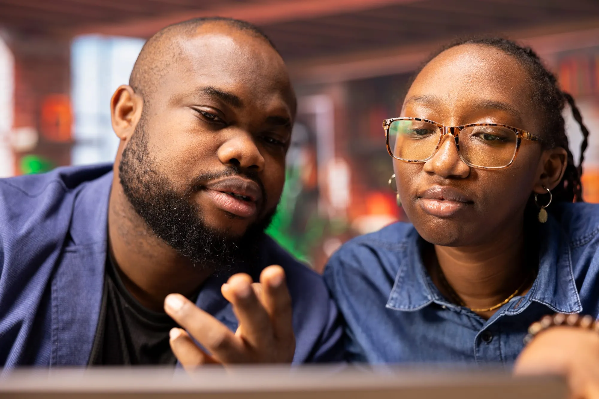 A mentor working through a problem with a young person