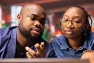 A mentor working through a problem with a young person